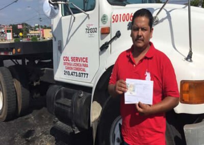 Close-up shot of a student's hands holding their newly acquired CDL license. Alt Text: A close-up of a student's hands proudly clutching their CDL license, symbolizing their achievement in Goodyear AZ CDL training.